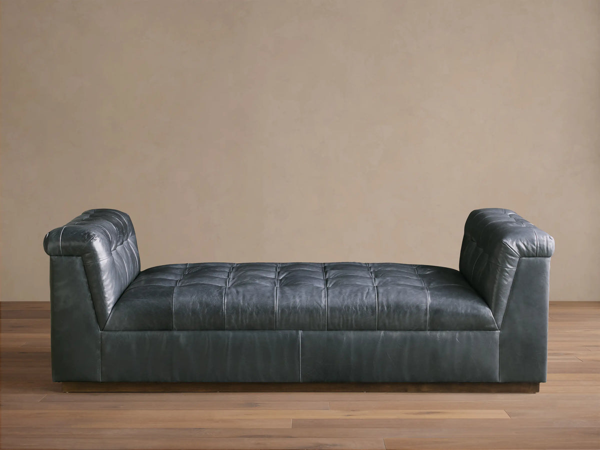 Front view of the Slate Cameran Leather Daybed with a tufted seat and integrated tufted armrests.