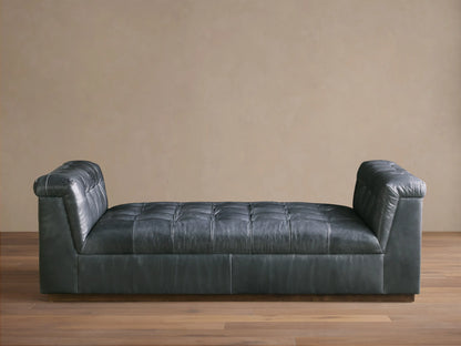 Front view of the Slate Cameran Leather Daybed with a tufted seat and integrated tufted armrests.