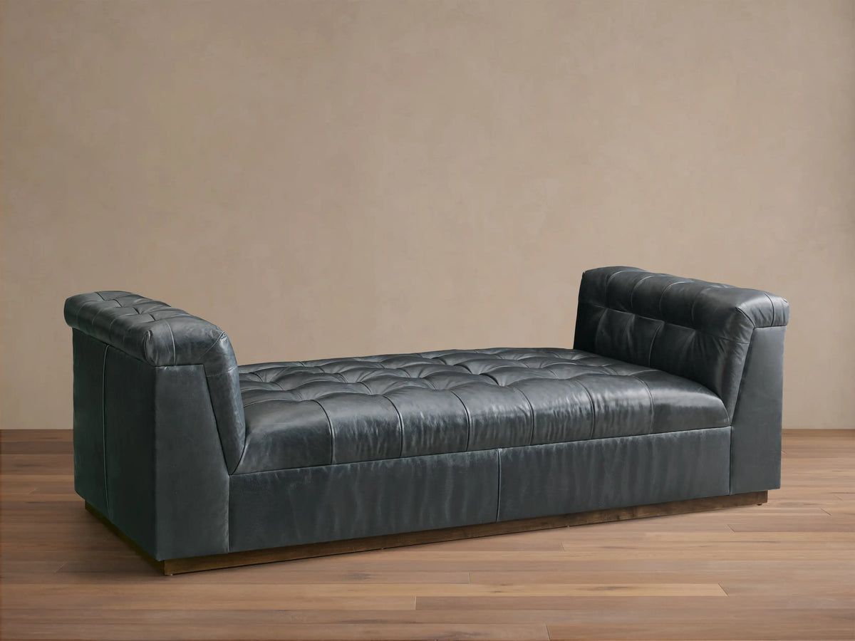 Front view of the Slate Cameran Leather Daybed with a tufted seat and integrated tufted armrests.