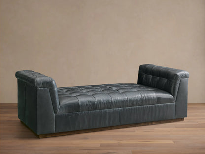 Front view of the Slate Cameran Leather Daybed with a tufted seat and integrated tufted armrests.