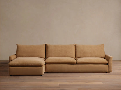 The Calistoga Two-Piece Chaise Sectional in tan fabric, featuring a left-side chaise and three-seat design, shown in a minimalist room.