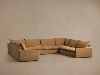Five-piece sectional sofa in tan fabric, set in a spacious room, featuring a casual design with slight fabric wrinkles.