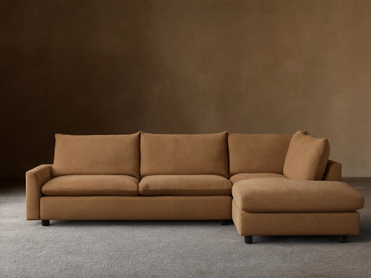 Calistoga Two-Piece Sectional in a light brown fabric. L-shaped design with plush cushions, set on a wooden floor against a neutral wall.