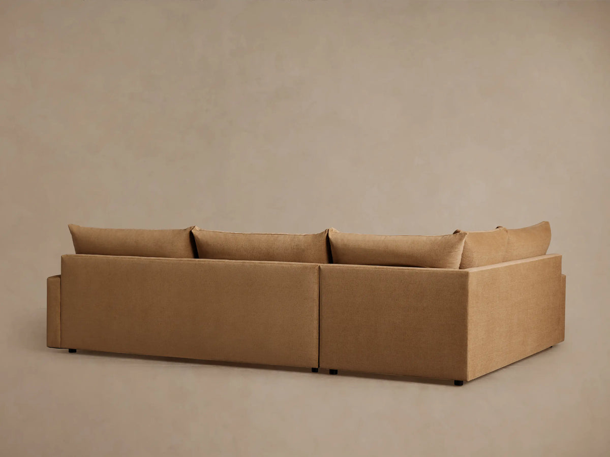 Tan Calistoga Two-Piece Sectional with soft fabric and plush cushions, showcasing its wide armrest and seamless design.