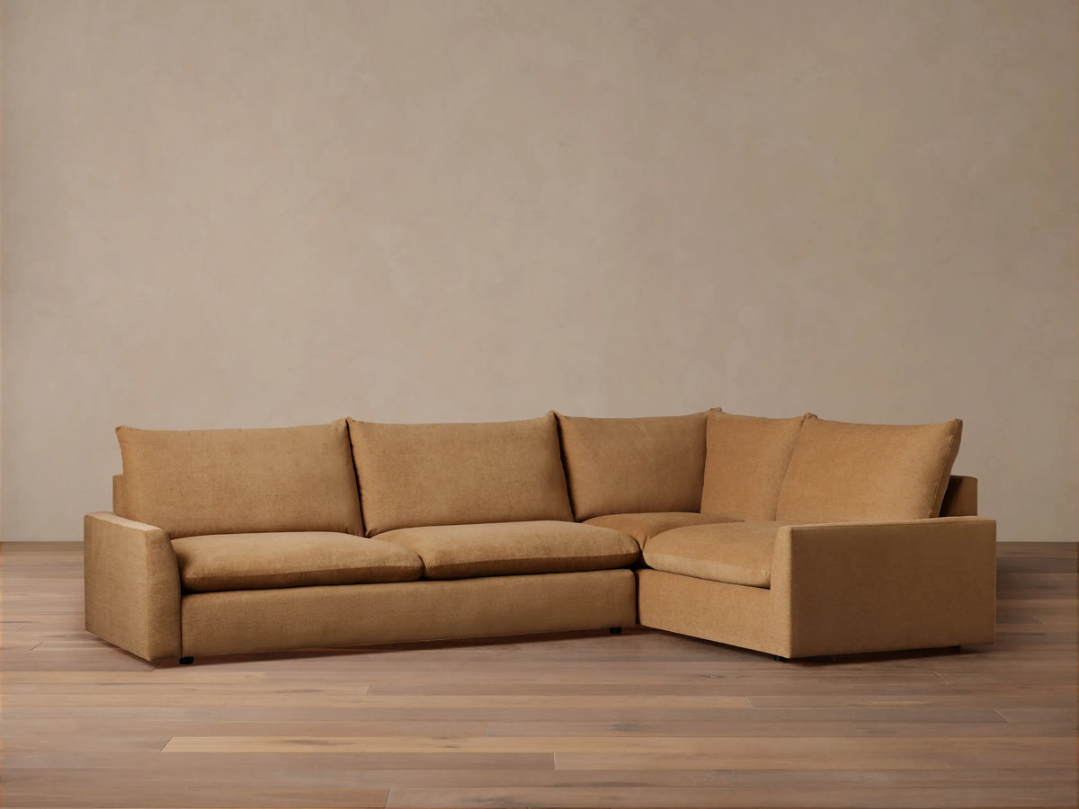 Calistoga Two-Piece Sectional in light brown fabric, featuring three seat cushions and an L-shaped design on a wooden floor.