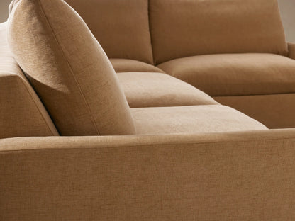 Calistoga Two-Piece Sectional in warm brown fabric, L-shaped design on wood floor, featuring plush cushioned seats and backrests.