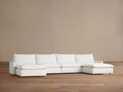Calistoga Four-Piece Sectional in off-white, with left and right chaises, against a neutral brown wall and wood floor.