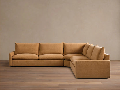 Front view of the ochre Calistoga Three-Piece Corner Wedge Sectional, with plush cushions and a low profile.