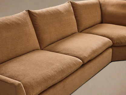 Corner view of the Tan Calistoga Three-Piece Corner Wedge Sectional, highlighting its plush seat and back cushions.