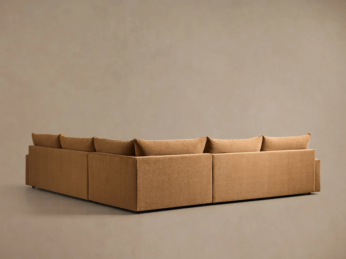 Front view of the ochre Calistoga Three-Piece Corner Wedge Sectional, with plush cushions and a low profile.