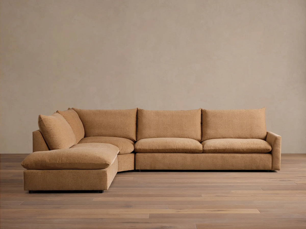 Front view of the Tan Calistoga Three-Piece Bumper Sectional, showcasing its L-shaped configuration.
