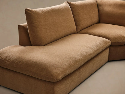 Front view of the Tan Calistoga Three-Piece Bumper Sectional, showcasing its L-shaped configuration.