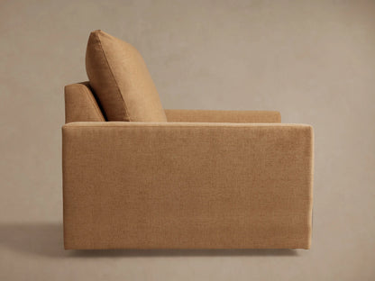 Calistoga Chair close-up showing a soft brown fabric with slightly relaxed texture, padded cushion and armrest, highlighting comfort.