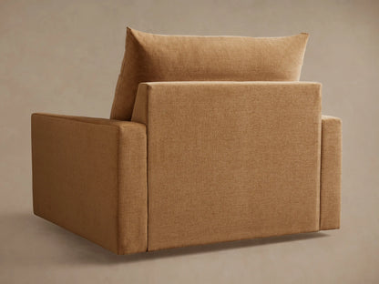 Calistoga Chair in tan fabric, side view. Features cushioned backrest and seat, flat armrest, and subtle fabric texture.
