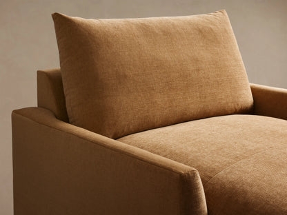 Rear angled view of a tan Calistoga Chaise with a plush back cushion and structured arms, extending to the left.
