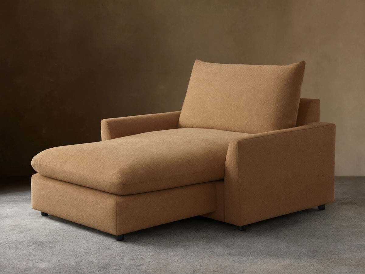 Angled front view of the tan Calistoga Chaise, featuring a wide seat and plump back cushion.
