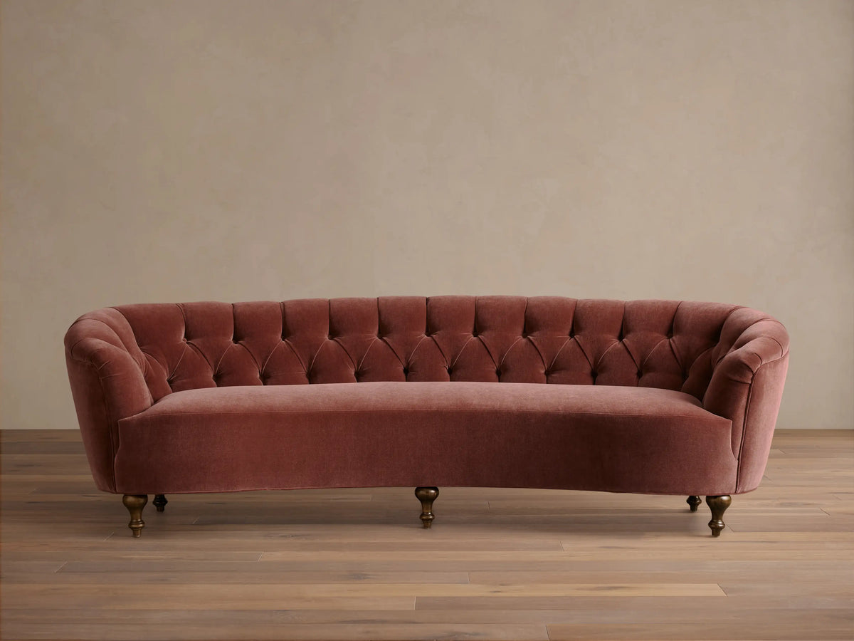 Front view of the dusty rose velvet Cortland Sofa with deep button tufting and mocha-finished turned wooden legs.