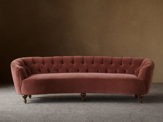 Front view of the dusty rose velvet Cortland Sofa with deep button tufting and mocha-finished turned wooden legs.