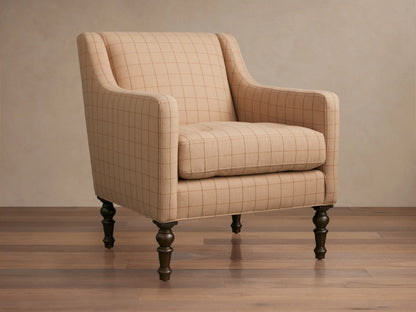 Fenwick Chair, light beige plaid armchair with rolled arms and dark turned wood legs, angled view on a wood floor.