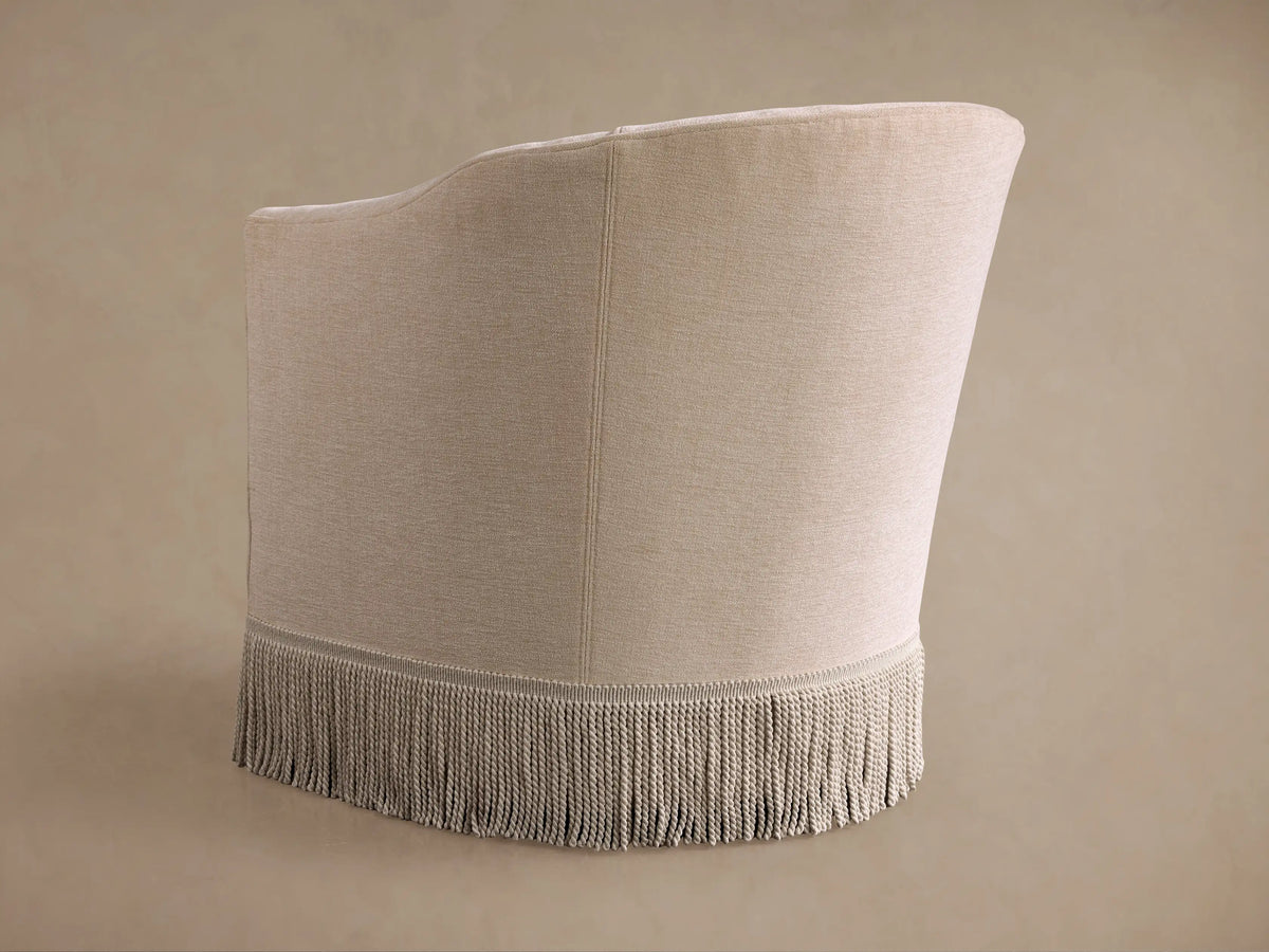 Close-up of a Giles Swivel Chair, showing a light beige, textured fabric armrest, seat cushion, and backrest.