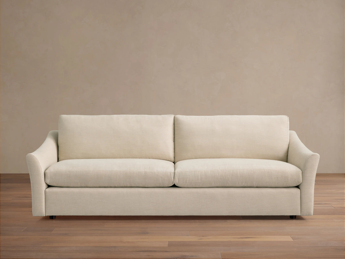 Helena Sofa in beige fabric, rear view. Features a clean, minimalist design with straight back cushions and curved armrest ends.