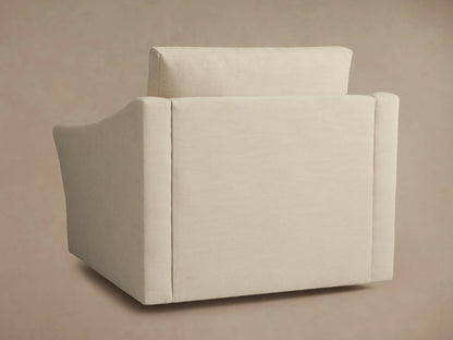 Alt text: Side view of the Helena Swivel Chair in cream-colored fabric, displaying its smooth, curved armrest and plush backrest.