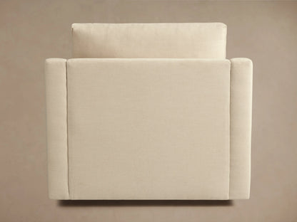 Helena Swivel Chair in beige fabric, viewed from the back showing its soft cushion and sleek, curved armrests on a neutral background.