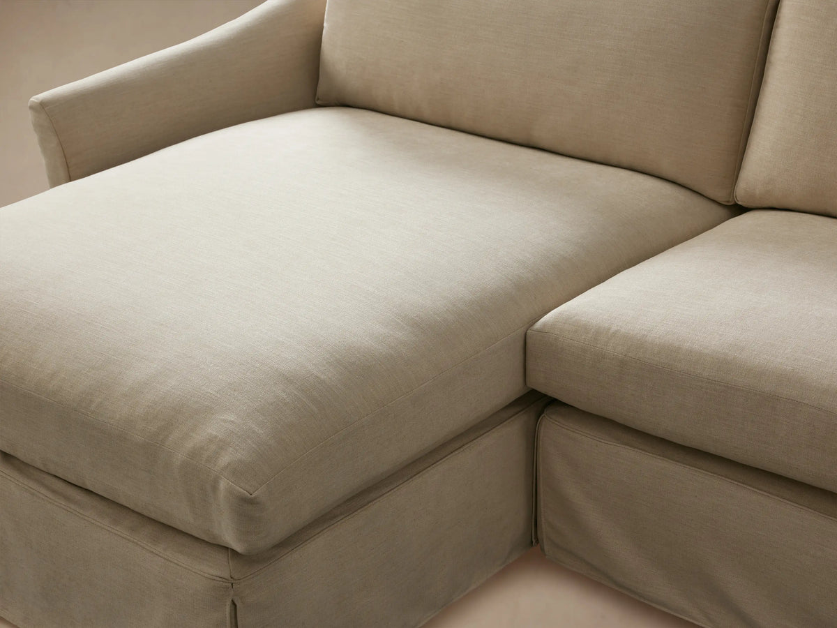 Helena Slipcovered Two Piece Chaise Sectional in light beige, L-shaped with a left-facing chaise, on wood floor.