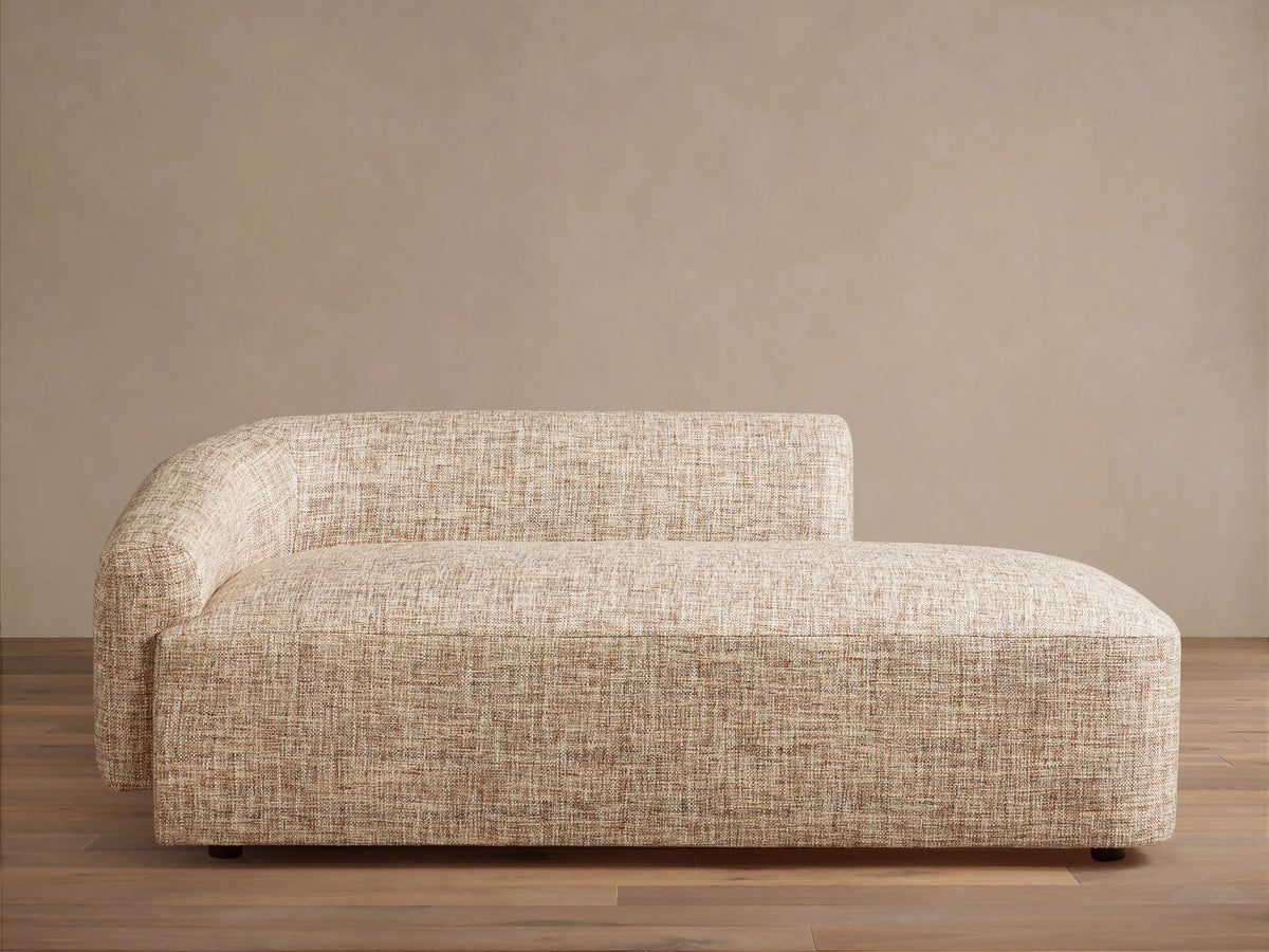 Hamlin Daybed: Modern armless chaise lounge in light beige textured fabric, with a curved backrest on the left.