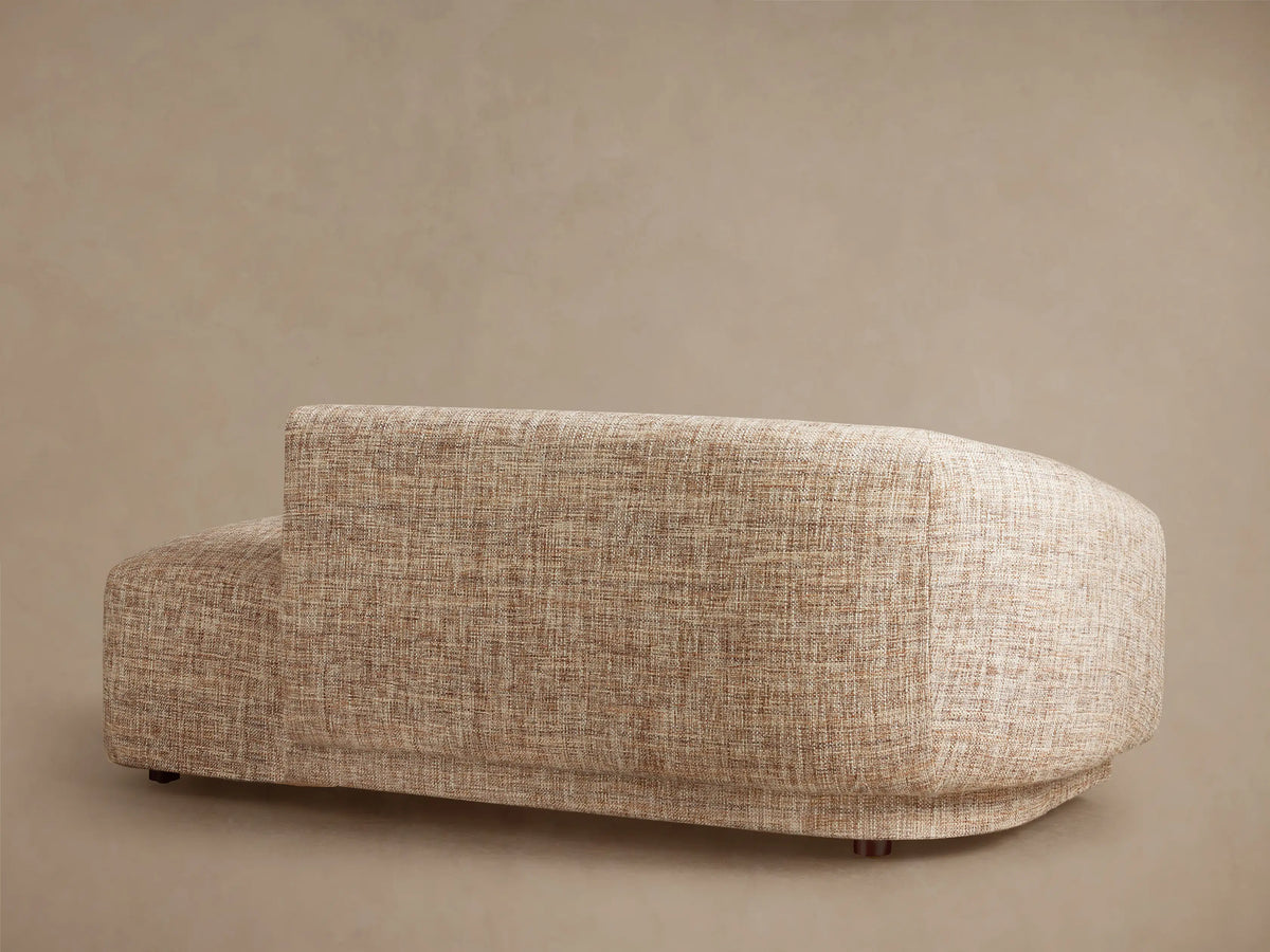 Hamlin Daybed: Modern armless chaise lounge in light beige textured fabric, with a curved backrest on the left.