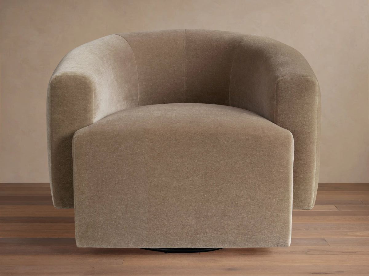 Interior view of a golden brown Hamlin Swivel Chair™ with a rounded back and skirted base.