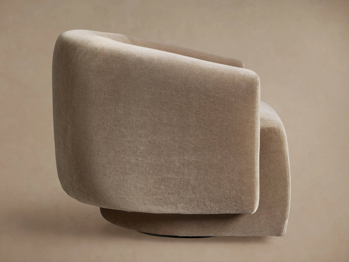 Hamlin Swivel Chair, light beige plush fabric, rounded back and side view, showing its dark, recessed swivel base.