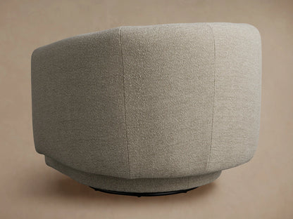 Close-up of the Hamlin Swivel Chair's curved armrest and back, featuring a light beige, subtly textured upholstery fabric.