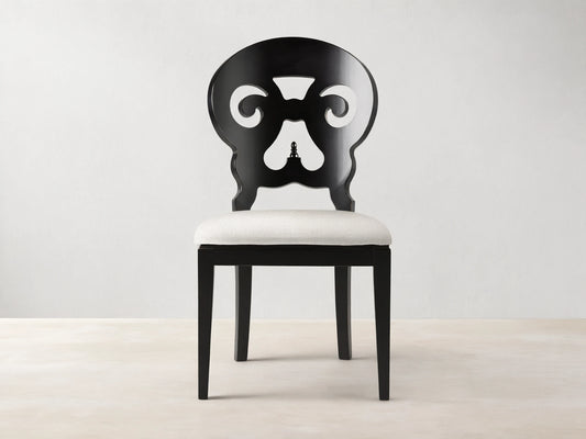 Jordan Dining Side Chair in Midnight; black wood frame with ornate back design, white padded seat, on white background.