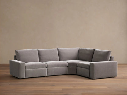 Front view of the grey Kipton Wide Arm Four-Piece Motion Sectional, an L-shaped sofa with plush cushions.