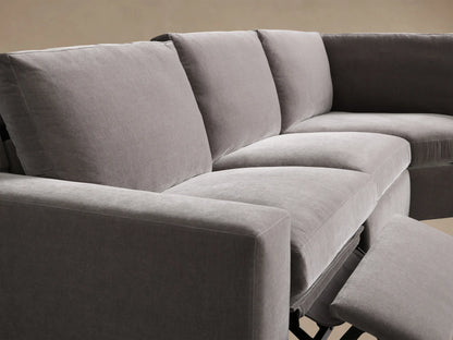 Close-up of the grey Kipton Wide Arm Four-Piece Motion Sectional's textured armrest with an oval taupe two-button motion control.