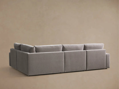 Close-up of the grey Kipton Wide Arm Four-Piece Motion Sectional, showing a wide arm and an extended footrest on a reclining seat.