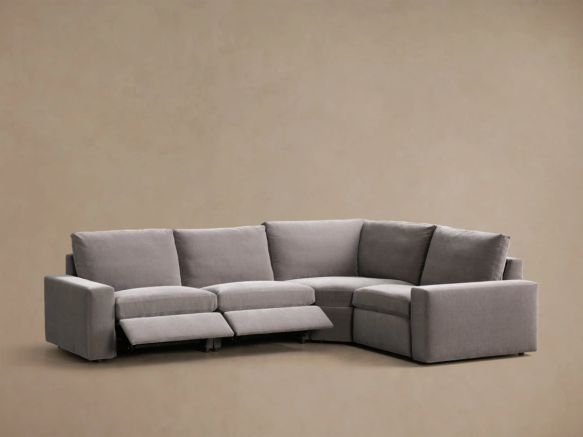 Rear view of the gray Kipton Wide Arm Four-Piece Motion Sectional, showing its L-shape configuration.