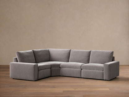Front view of the grey Kipton Wide Arm Four-Piece Motion Sectional, an L-shaped sofa with wide arms and plush upholstery.