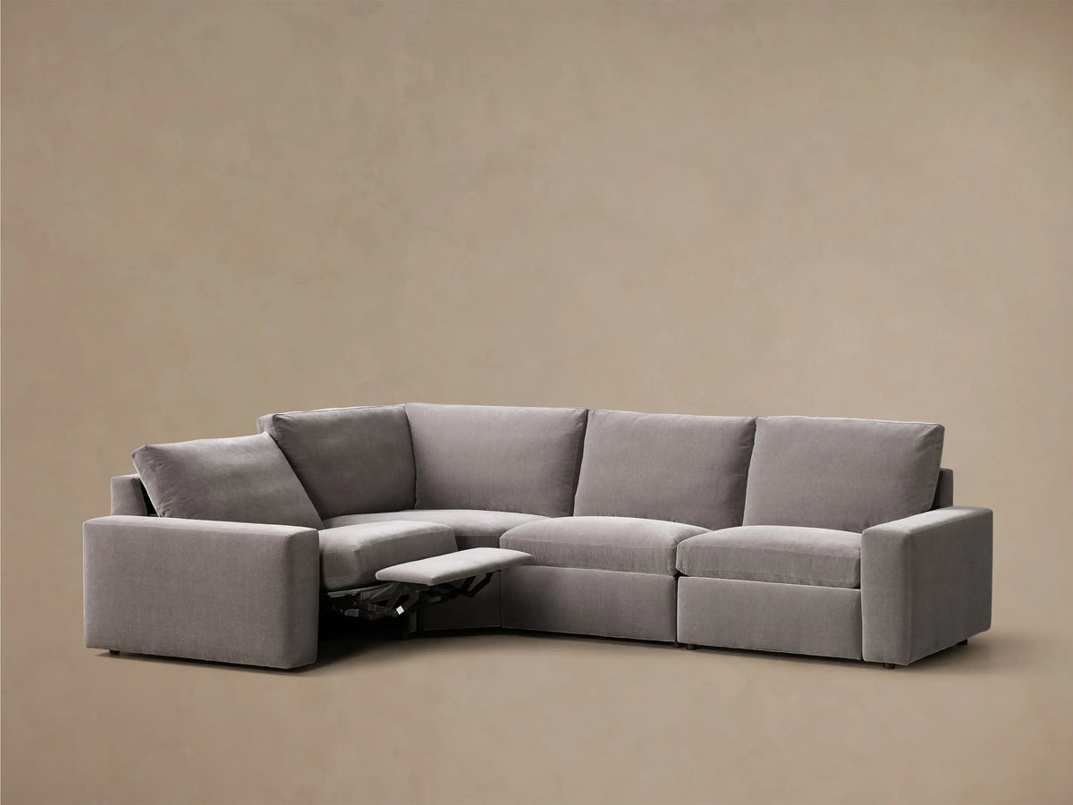 Front view of the grey Kipton Wide Arm Four-Piece Motion Sectional™ with two footrests extended.