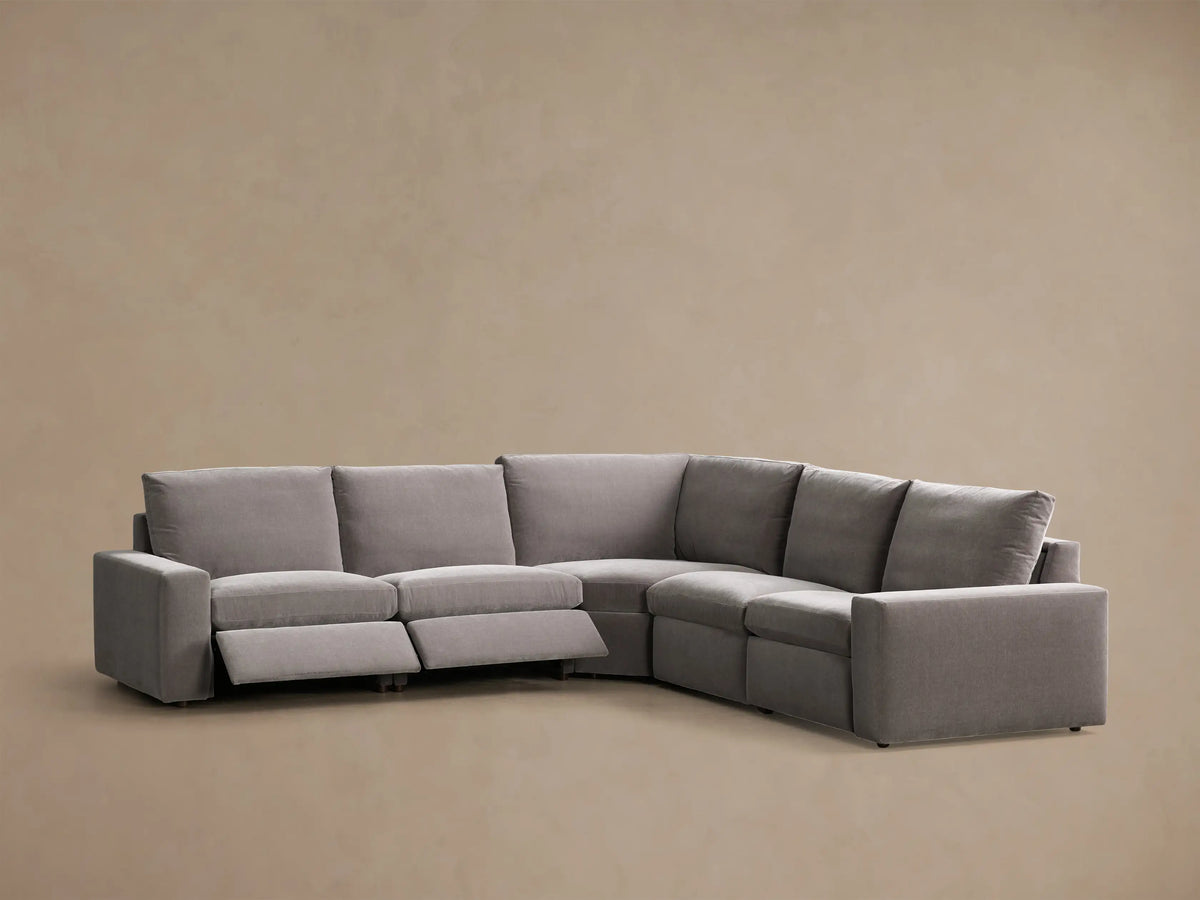 Front view of the grey Kipton Wide Arm Five-Piece Motion Corner Sectional with two extended footrests.