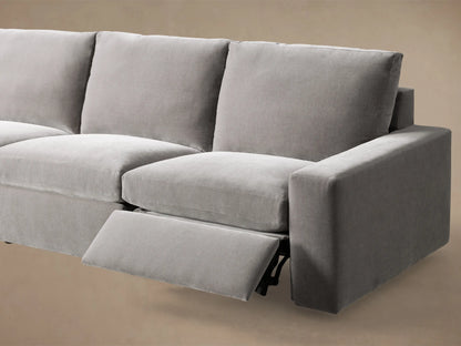 Close-up of the grey Kipton Wide Arm Six Piece Motion Sectional, showing a metallic motion control button on the wide arm.