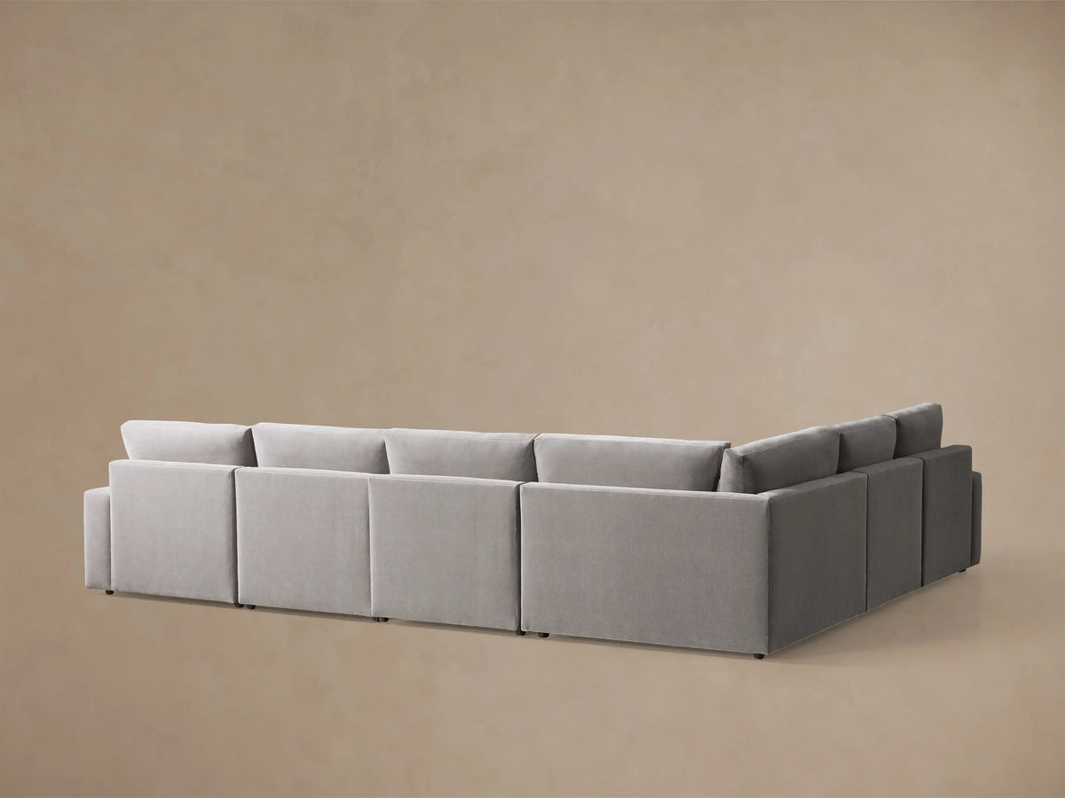 Front view of the gray Kipton Wide Arm Six Piece Motion Sectional with the motion footrest extended.
