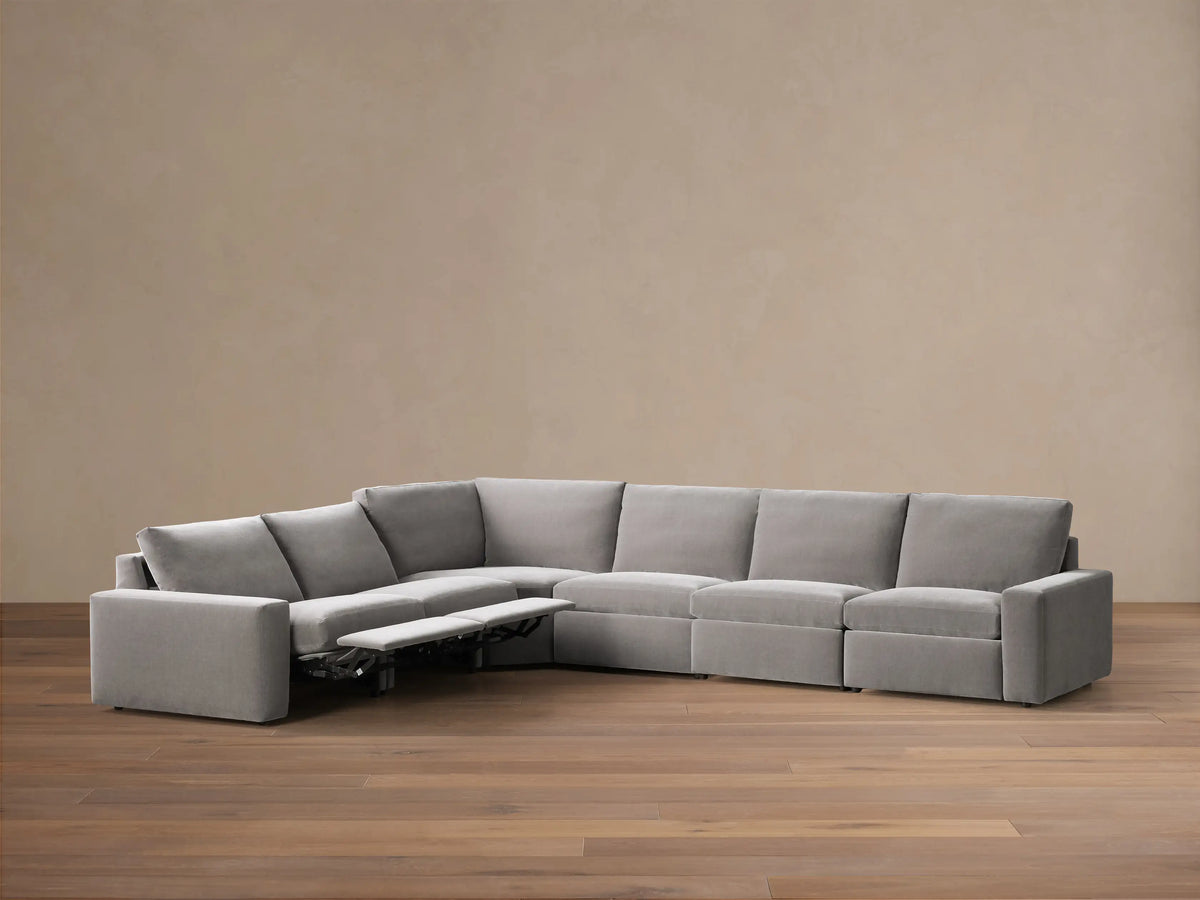 Rear view of the gray Kipton Wide Arm Six Piece Motion Sectional, showing its L-shape configuration.
