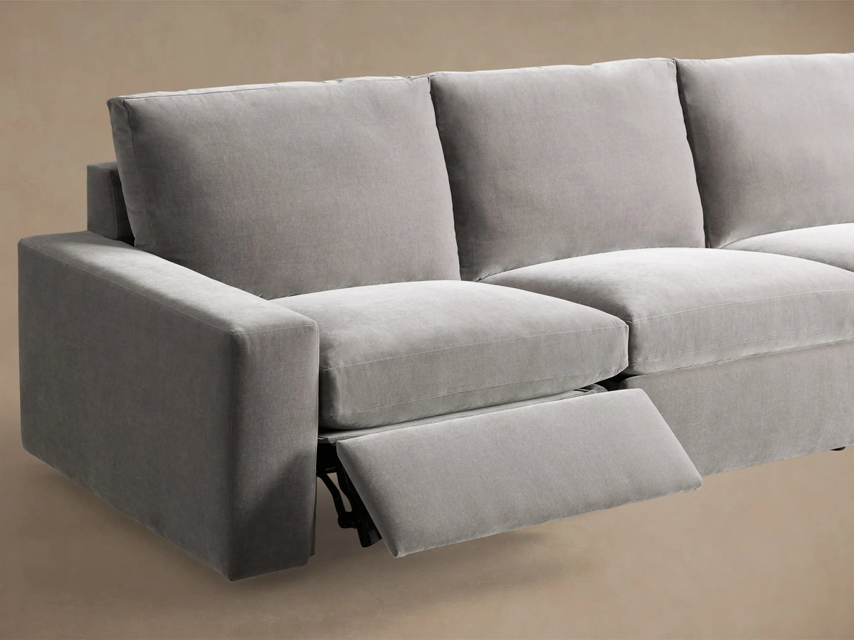 Close-up of the grey Kipton Wide Arm Six Piece Motion Sectional's arm, showing its two-button metallic motion control.