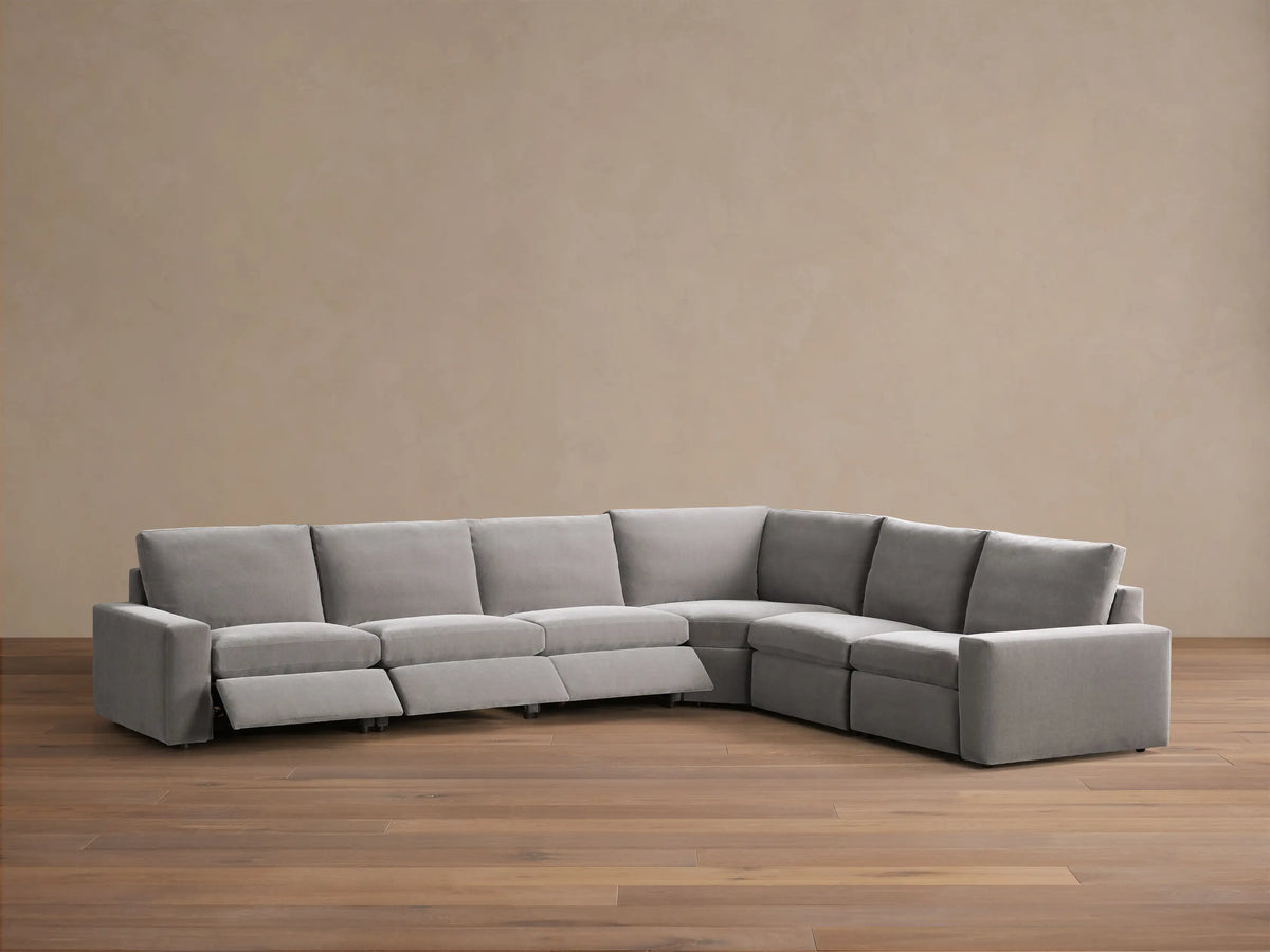 Rear view of a light grey Kipton Wide Arm Six Piece Motion Sectional, showing its L-shaped modular design.