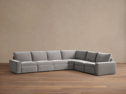 Front view of the light gray Kipton Wide Arm Six Piece Motion Sectional, with two reclined seats showing extended footrests.