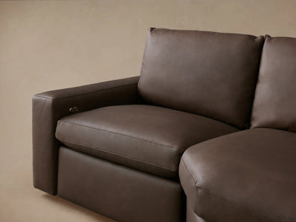 Close-up of Kipton Wide Arm Leather Motion Sectional, dark brown leather, detailed stitching, and chrome recline control.