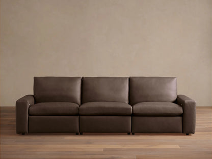 Kipton Wide-Arm Leather Three-Piece Motion Modular Sofa in rich dark brown, with plump cushions, on a wood floor.