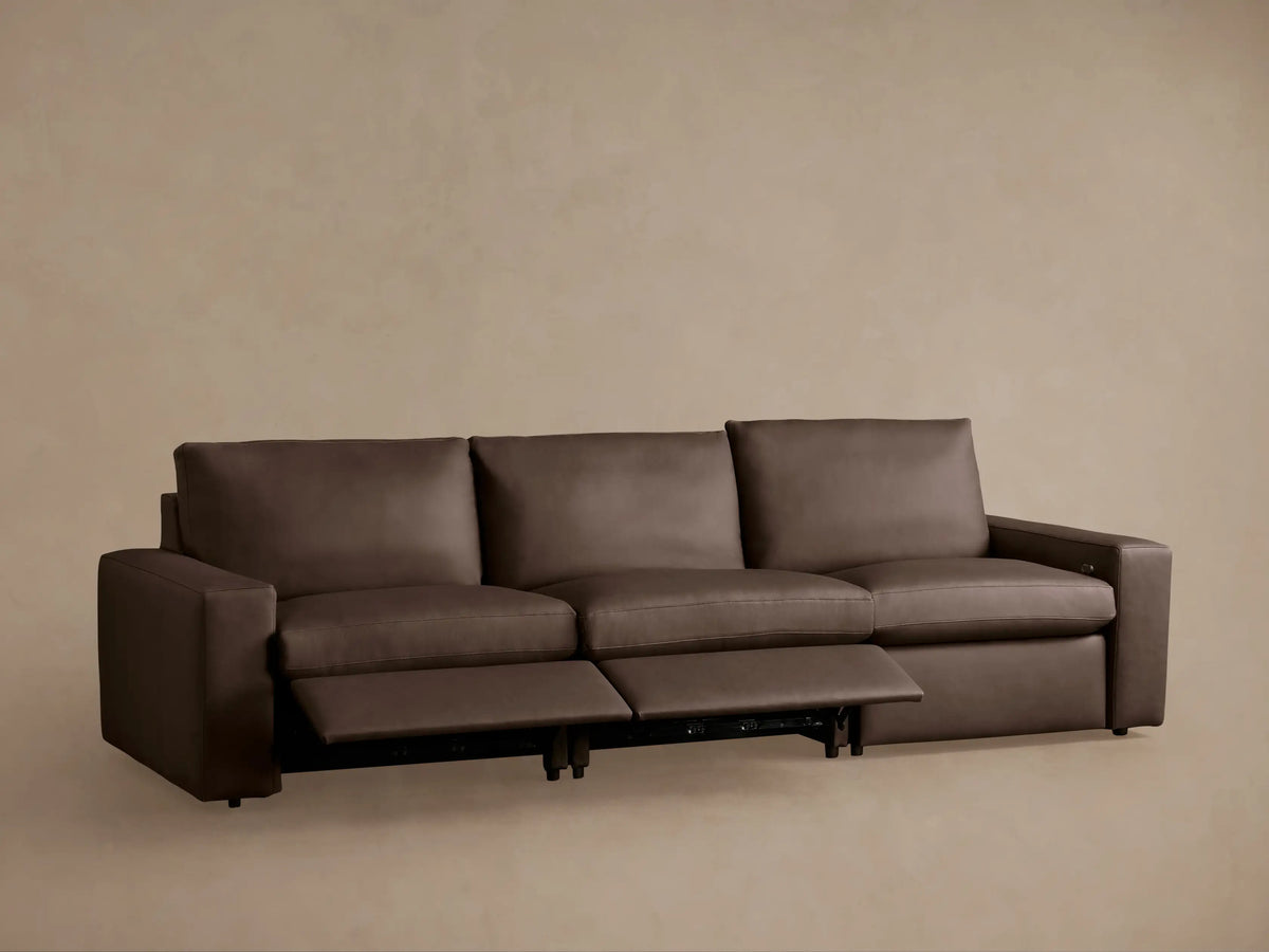 Back view of dark brown leather Kipton Wide-Arm Three-Piece Motion Modular Sofa, showing its distinct back sections.